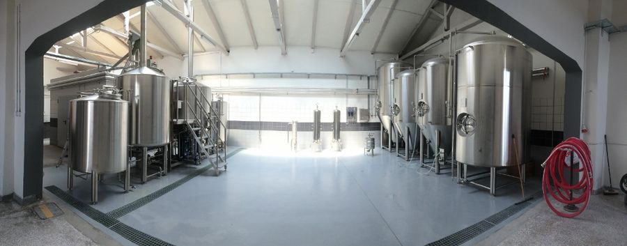 corridor of Noctua Brewery plant with beer brewing systems on the both sides