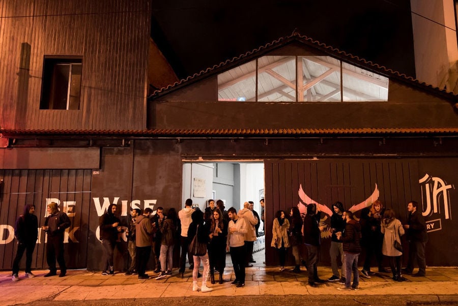 outside Noctua Brewery by night with persons drinking and discussing