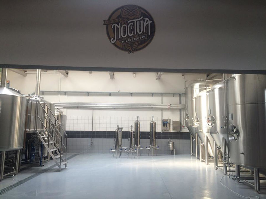 corridor of Noctua Brewery plant with beer brewing systems on the both sides