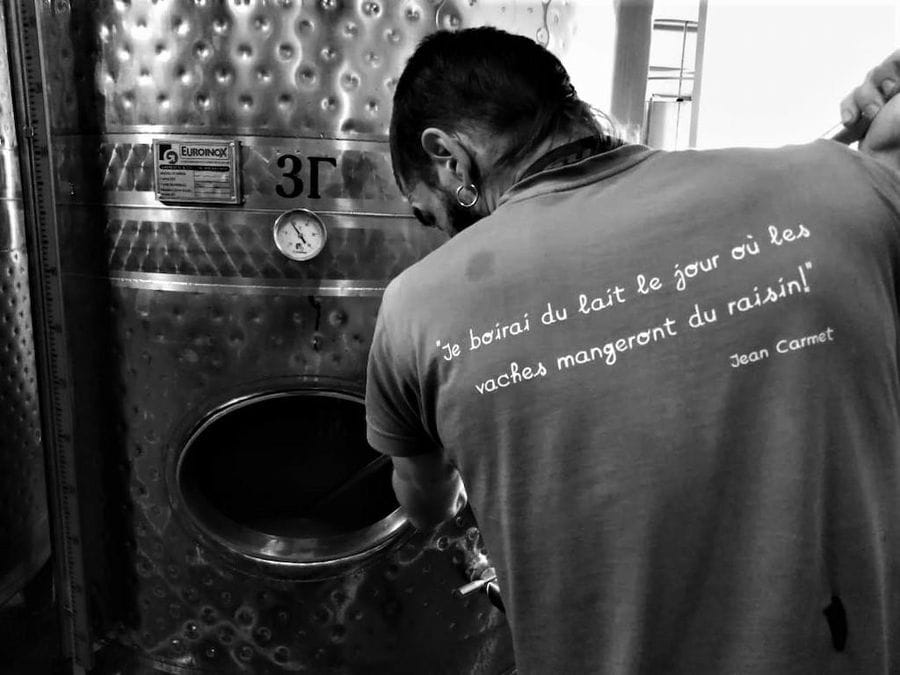 oenologist tasting the wine from storage tank at Rouvalis Winery