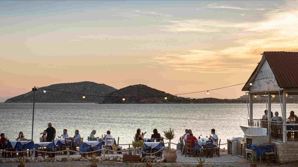 People eatin by the sea in a tavern