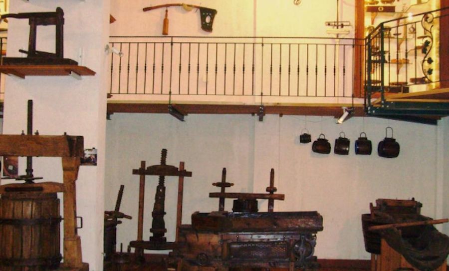 old vise and grape presses at Tzivani Bio Wines and an indoor balcony