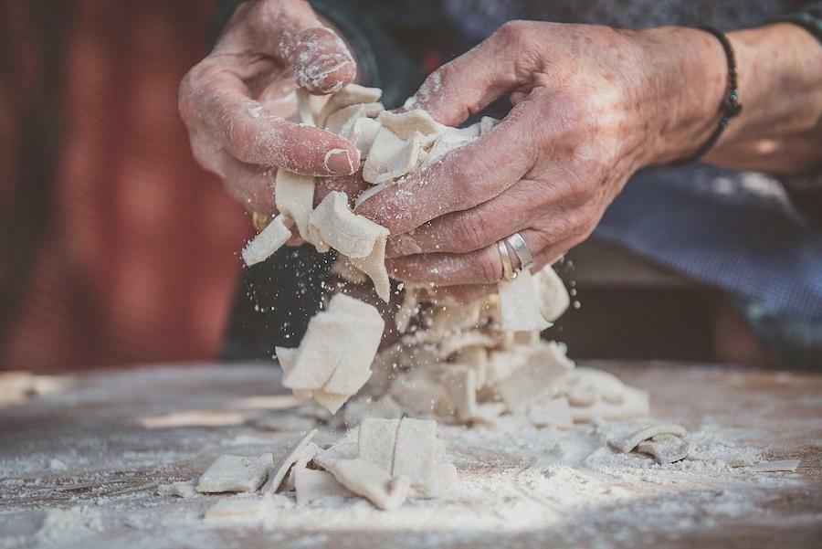 close-up of old woman making dough