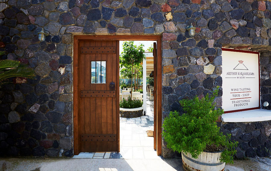 stone wall entrance with wood door at 'Artemis Karamolegos Winery'