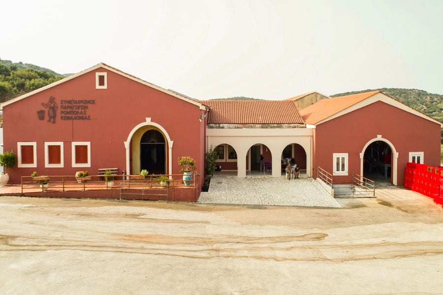 front view of the Orealios Gaea building with columns and arcades and stone pavement in front