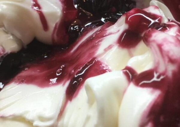 close-up of Greek ‘Kaimaki’ ice cream like vanilla ice cream with heights syrup on top