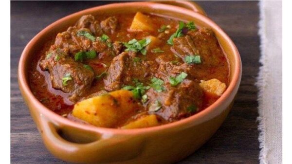 Greek ‘patatato’ cooked over a slow fire in a pan with tomato paste