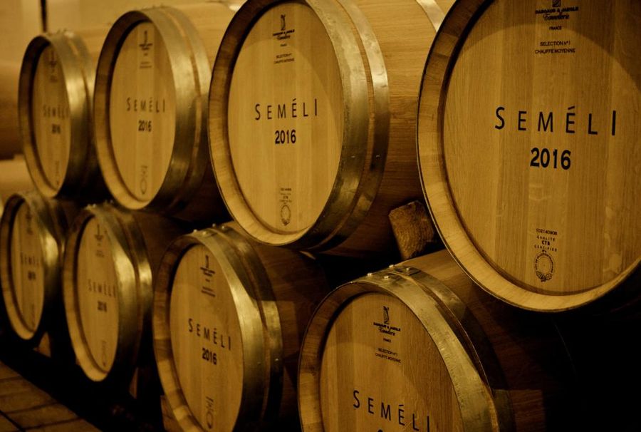 personalized wooden wine barrels sign with the Semeli Estate logo into the cellar