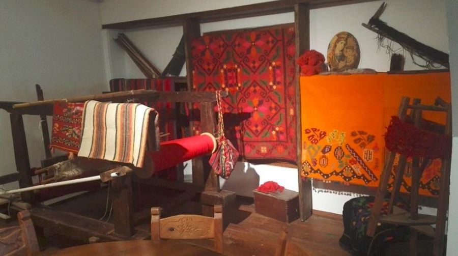 room on the folklore museum at Dourakis Winery with an old loom and folklore carpets