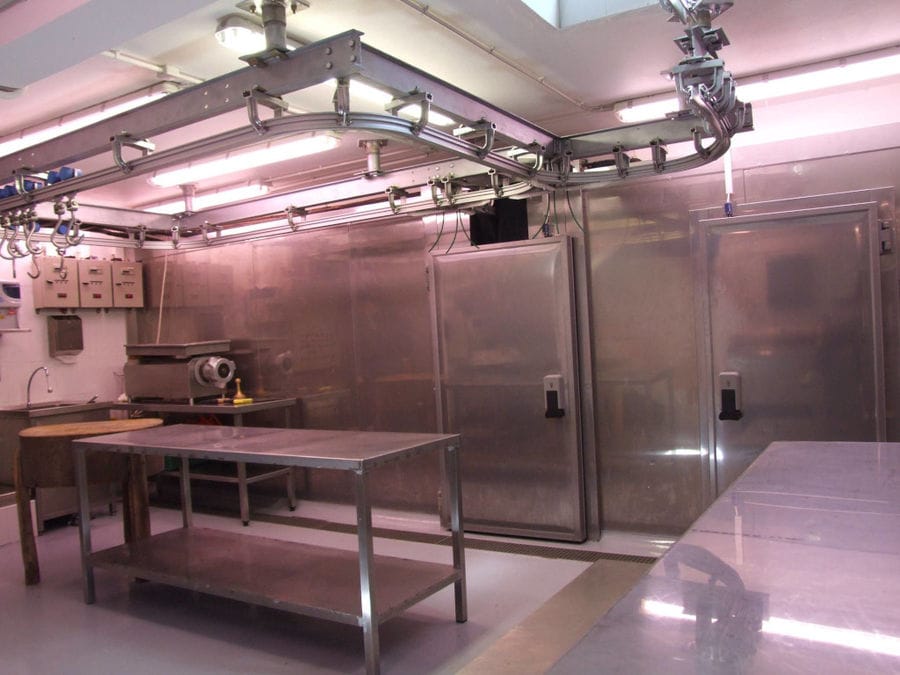 'Roussounelos Meat Market' cold room with meet refrigerators and aluminum table