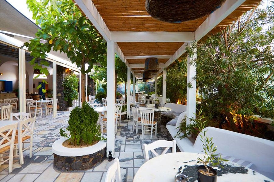 'Artemis Karamolegos Winery' garden restaurant outside with white tables and chairs