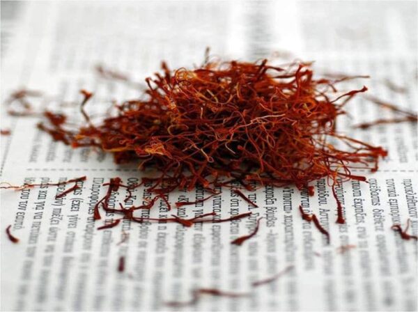 Dry Greek red Saffron on paper surface|