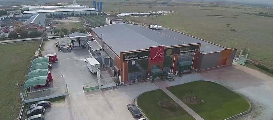 Sary's processed meet plant from above surrounded by parking with cars and green lawn