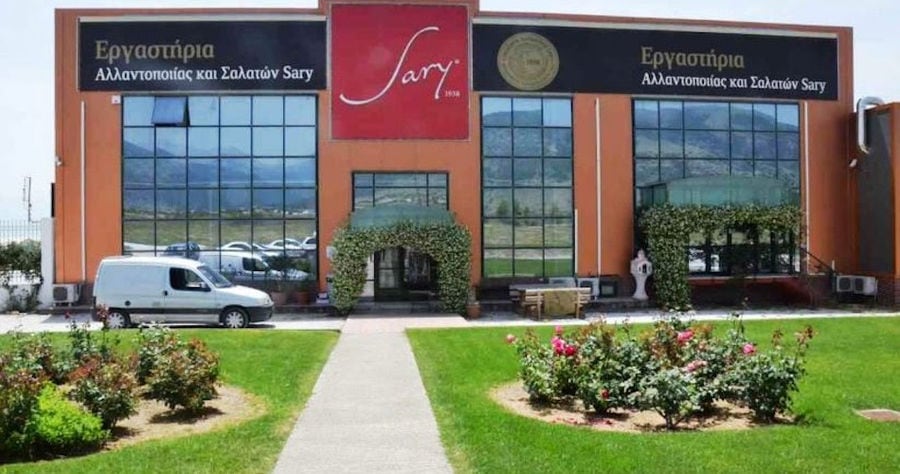 grass and flowers in front of the entrance of building that says 'Sary' in upper part of the wall