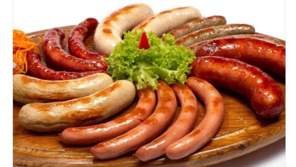 Grilled various sausages made from ground pork or beef with spices putting in circle and green fresh salad in center