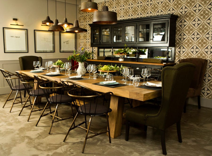 'Semeli Estate' tasting room with a wood tables and chairs and glasses