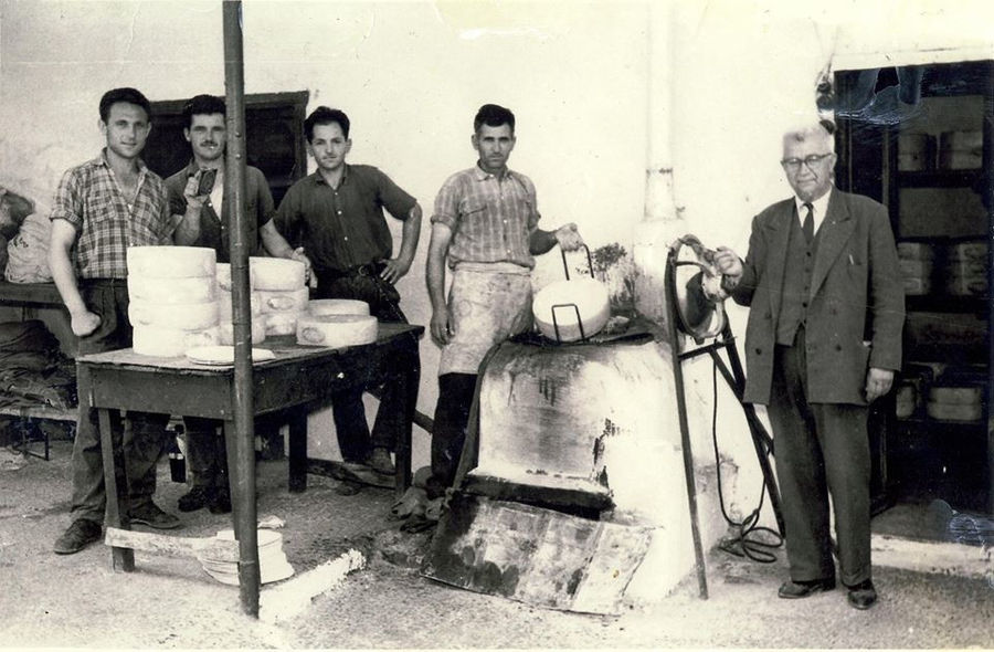 a old view of five men watching at the camera at Siafarikas Dairy plant
