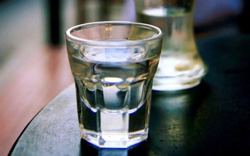 Close-up of glass with Transparent Greek ‘Souma’ is a colorless alcoholic beverage produced by the distillation of grapes