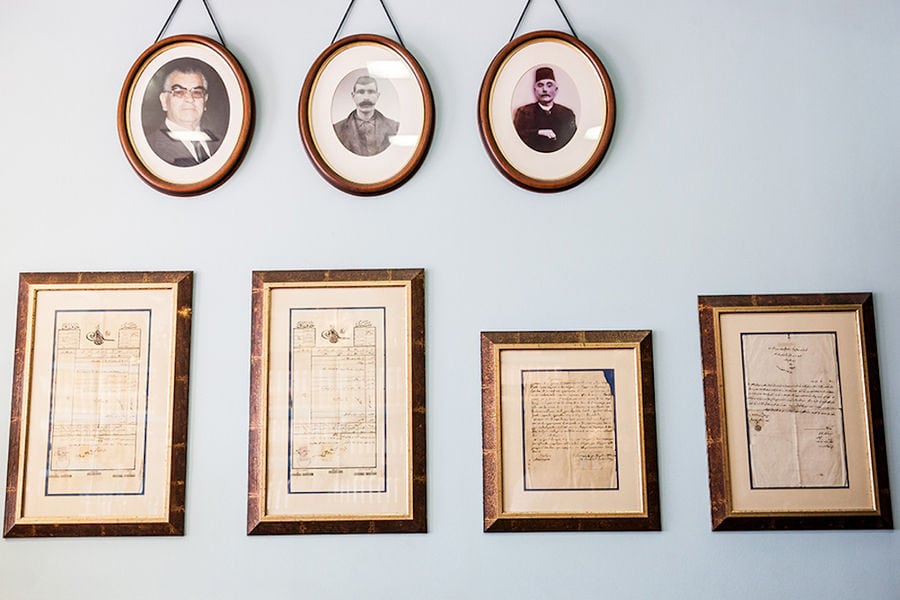 frames with awards and portrait photos on the wall at 'Spentza Distillery'