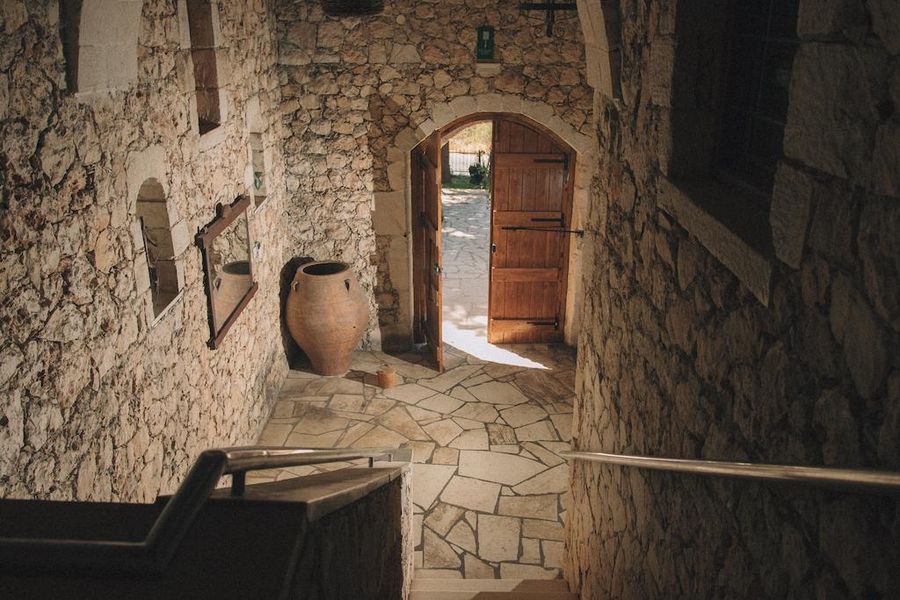 stone building Dourakis Winery entrance inside with wood door