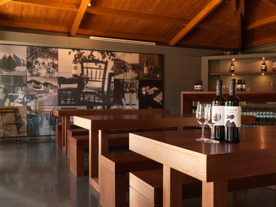 Strofilia winery tasting room with a montaj of photos on the wall in the buckround