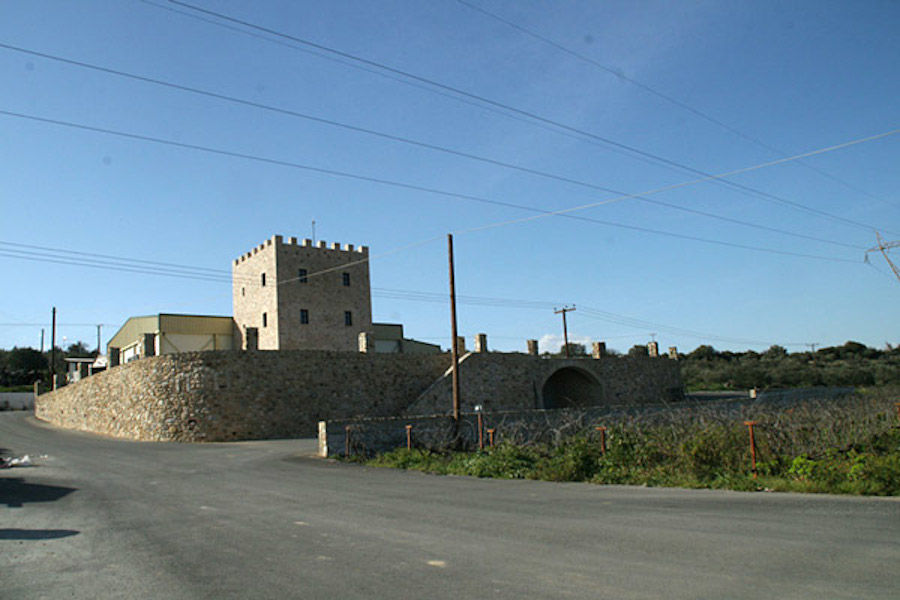 view from the road of front side of the stone tower of 'Theodorakakos Estate winery'