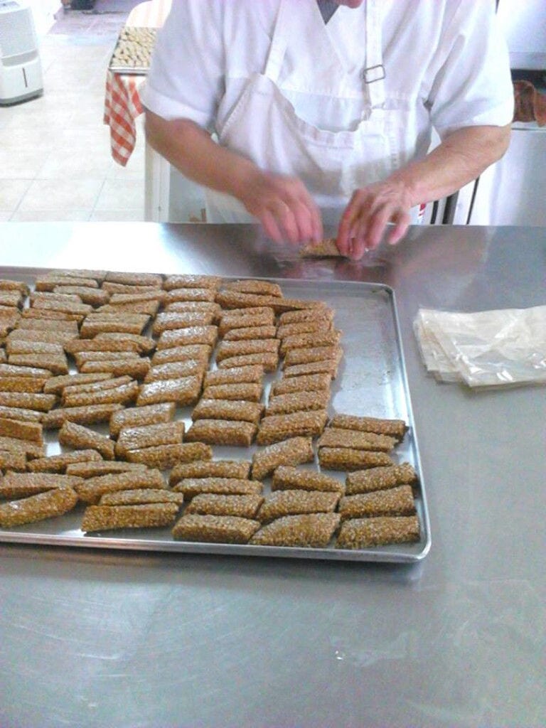 woman making sesame seed breadsticks at The Apolloniatisses workshop