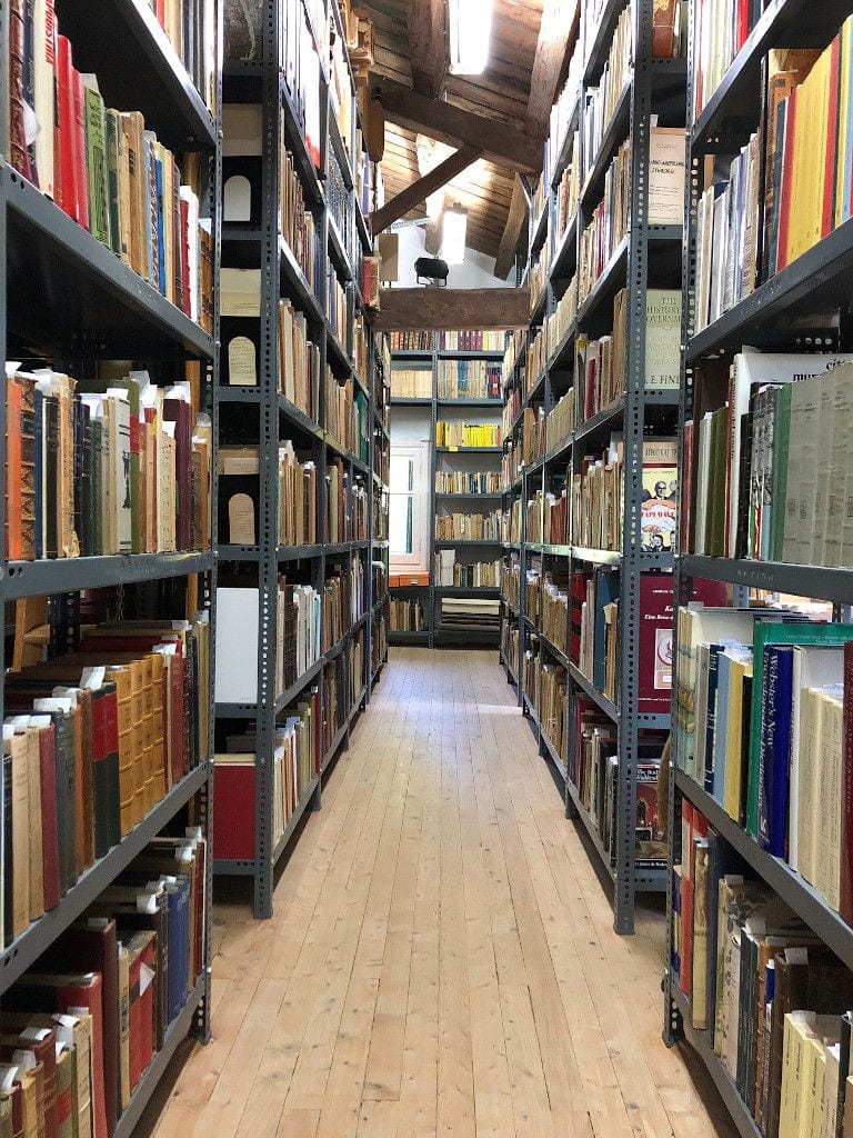 corridor of the 'Theotoky Estate' library with stacked books on top of each other storeged in frame lockers