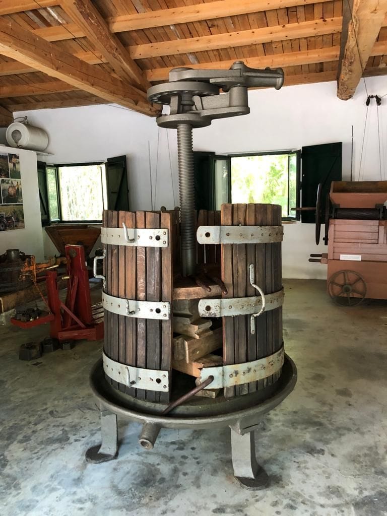 old manual grape press at 'Theotoky Estate' museum with wood ceiling