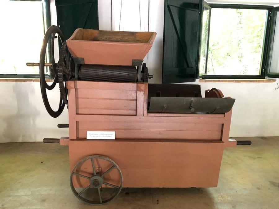 old manual grape press with two wheels at 'Theotoky Estate' museum