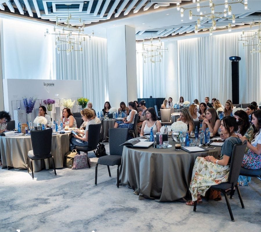 a group of tourits sitting at the tables and tasting 'Thesauri Caviar' food products