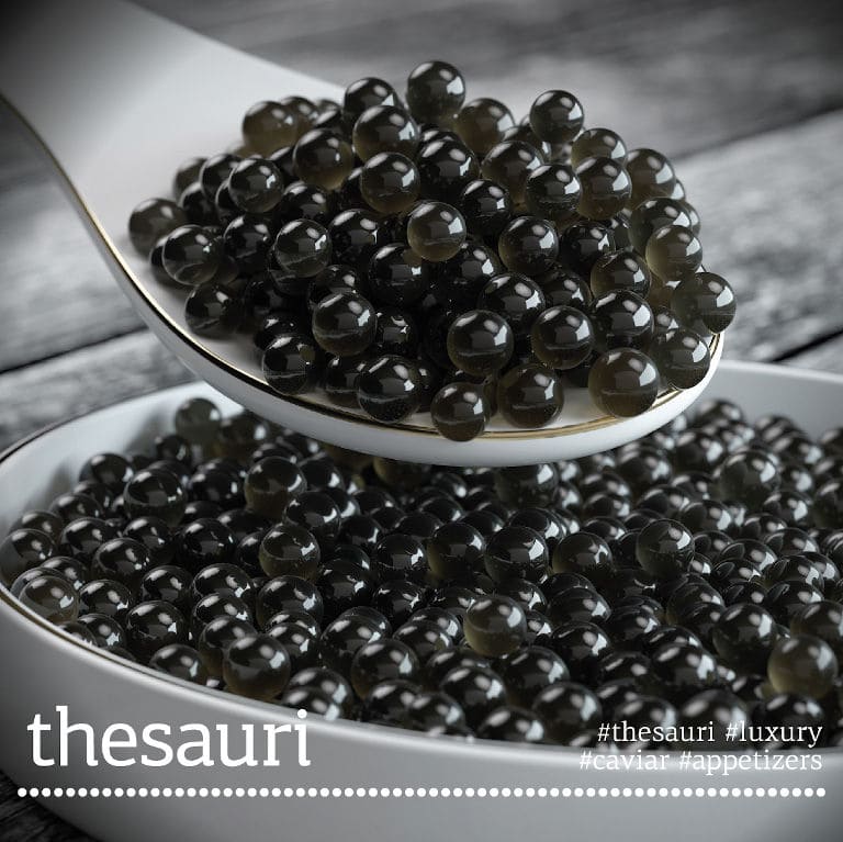 close-up of a bowl with caviar eggs from 'Thesauri Caviar' and a spoon with the same on top