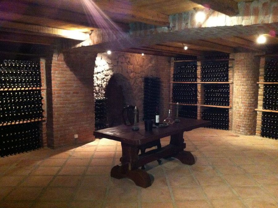 'La Tour Melas' stone cellar with stacked bottles on top of each other
