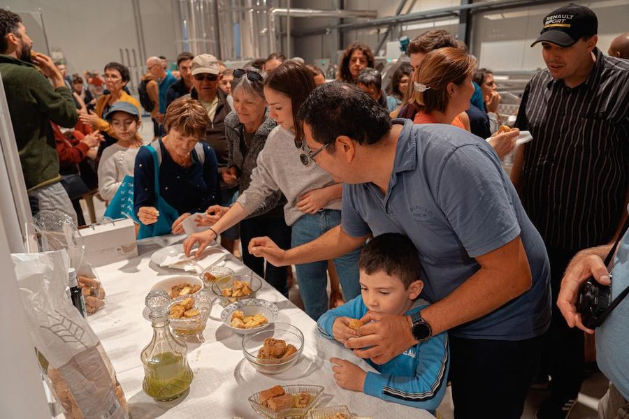 tourists tasting olive oil on breadsticks at Politakis Mill premises