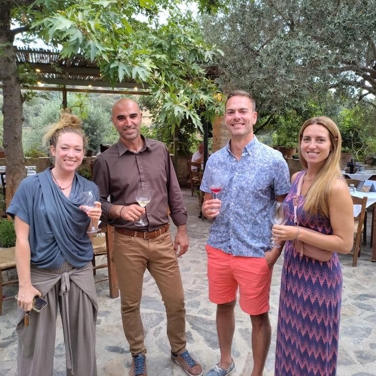 tourists with glasses of wine smiling at the camera at Ktima Toplou