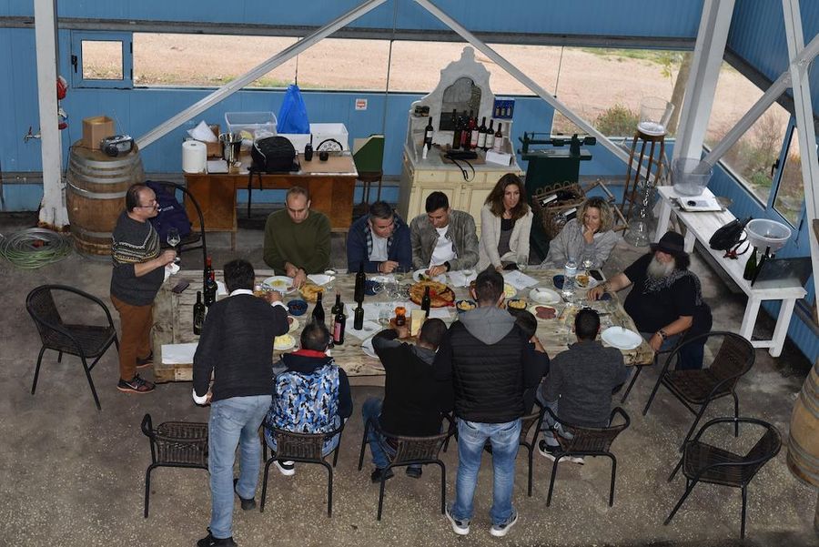 view from above of tourists tasting wines inside at winery and listening a guide-Gastronomy Tours.jpg