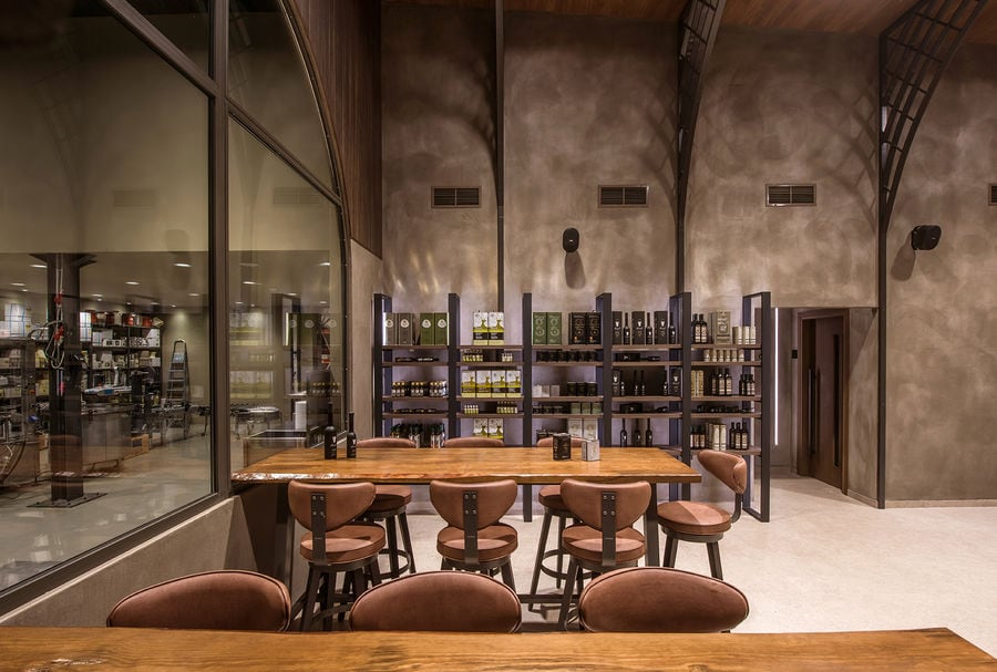 Savouidakis' Olive Oil Tasting Area, with 2 large tables and chairs.