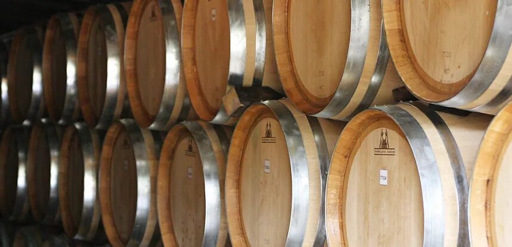 wood barrels on top of each other at Ktima Spiropoulos cellar|