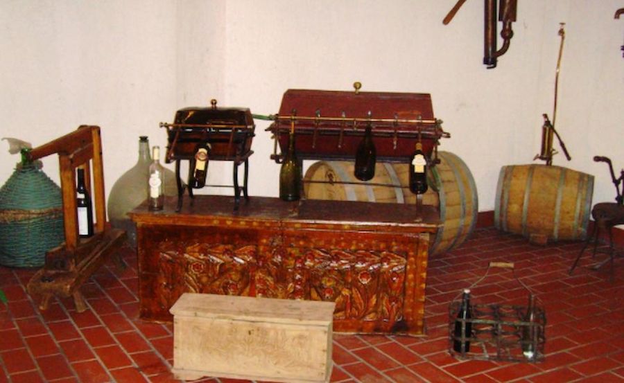 wood box baul with patterns and wooden barrels and wine jugs in the background at Tzivani Bio Wines