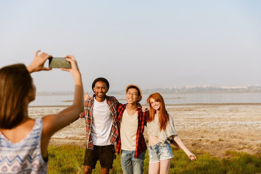 young-woman-taking-photo-his-friends-on-mobile-pho-2022-03-02-18-56-38-utc (1).jpg