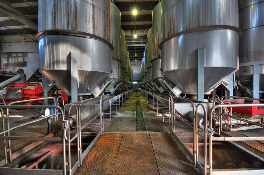 view starting at the base to the middle of aluminum wine storage tanks at 'Vaeni Naoussa' plant