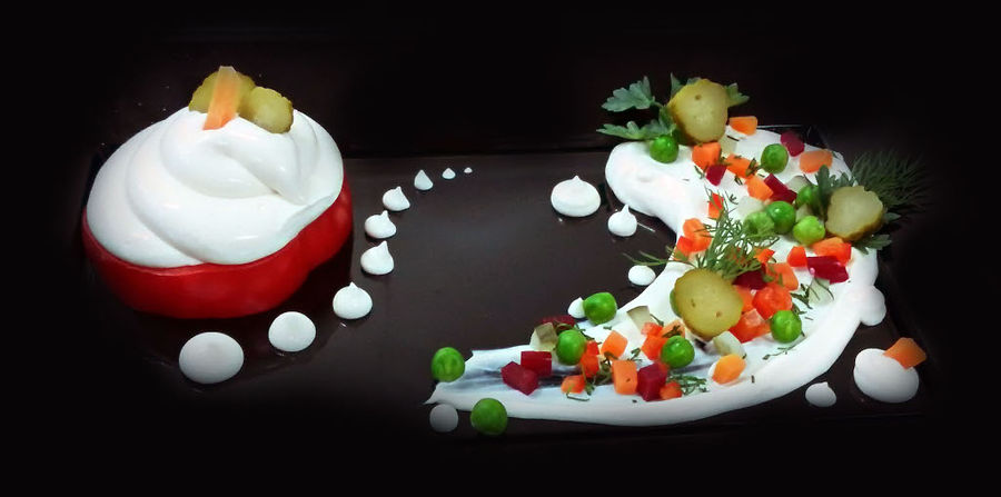 fresh cream cheese with pieces of pikcles on the top and a stuffed pepper with the same composition from 'Pitenis