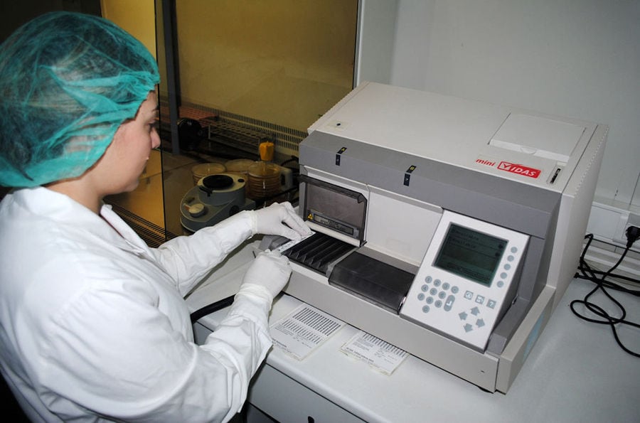 a woman working at analyzer at 'Pitenis' laboratory