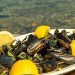 a plate of mussels and lemons