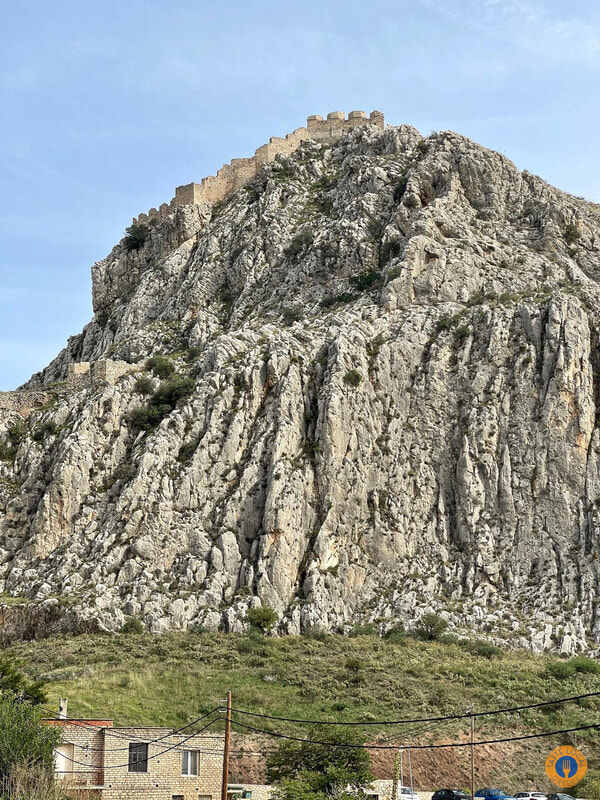a stone mountain with a castle on top