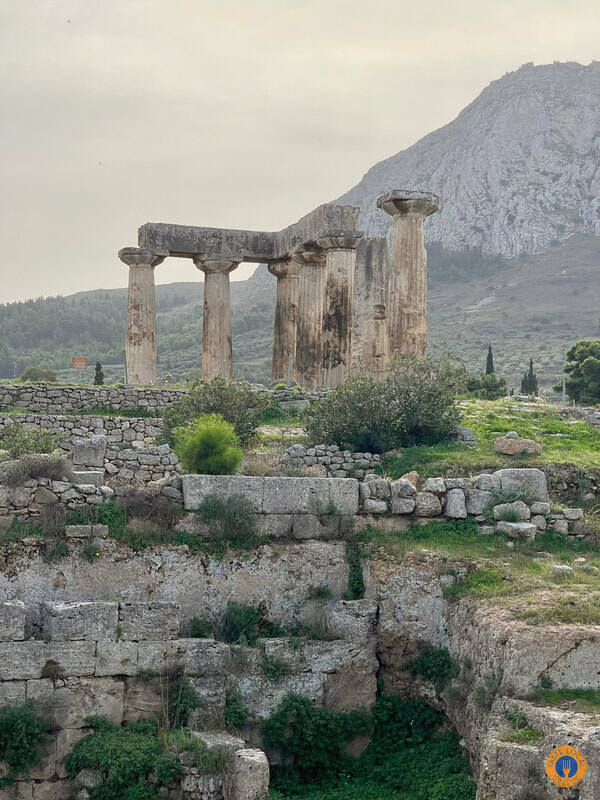 a stone ruins with a mountain in the background in Akrocorinthos