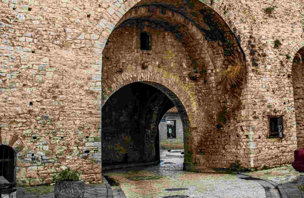 a stone archway with a brick wall