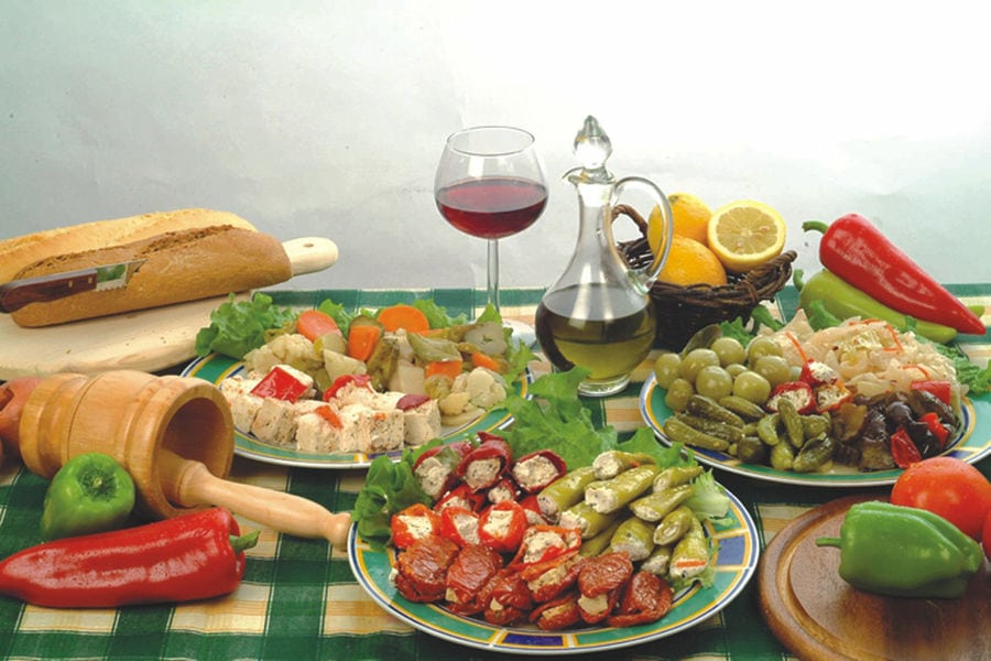 plate with various aperitifs from 'Pitenis' like stuffed pickles with salade and mayonnaise