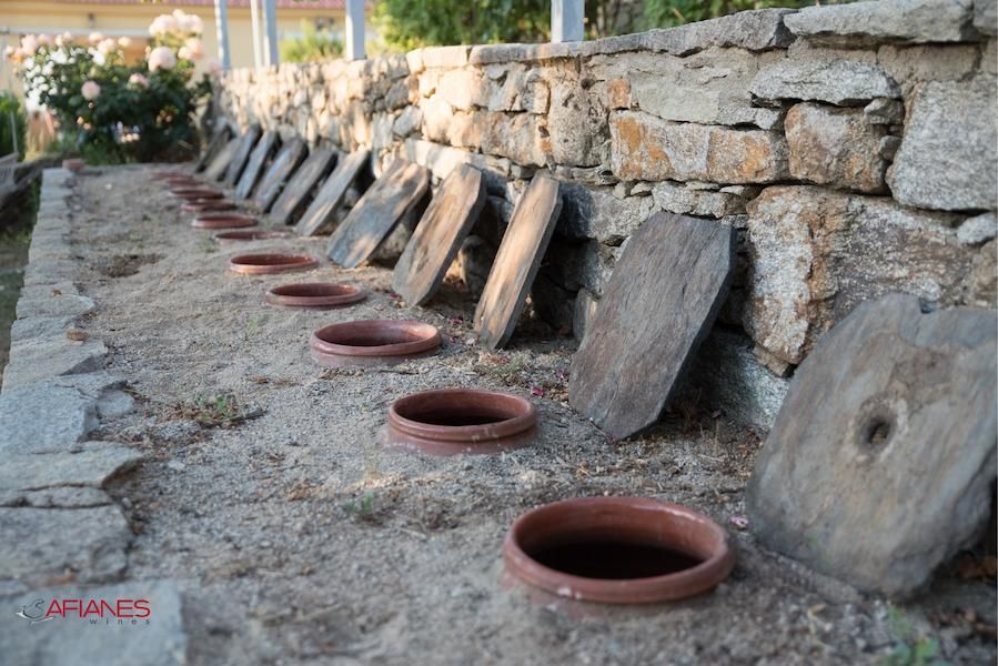 ceramic pots in line, half-burried in the sand – Gastronomy Tours.jpg