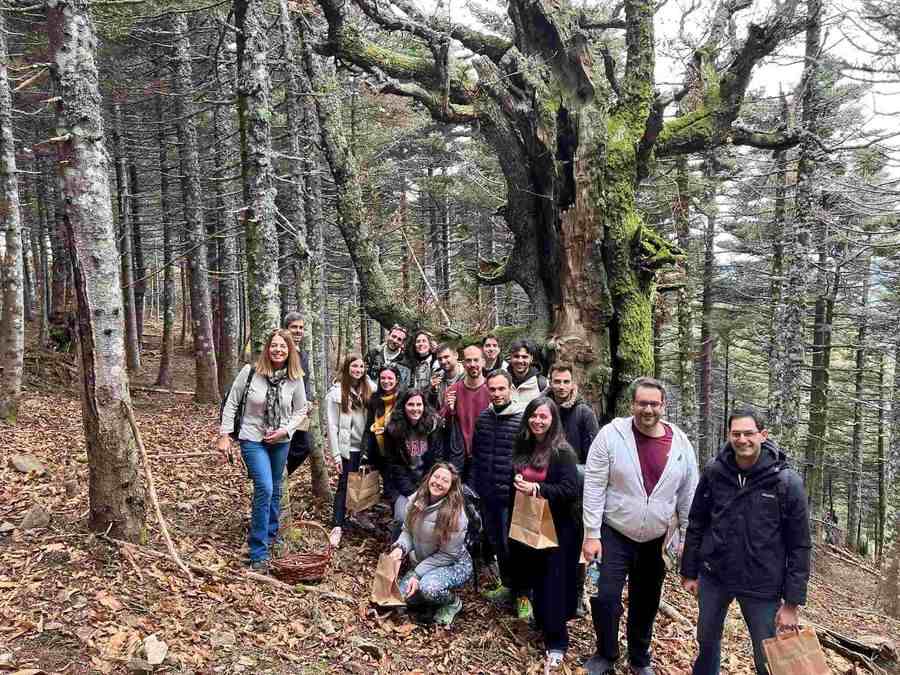 a group of people posing for a photo in the woods